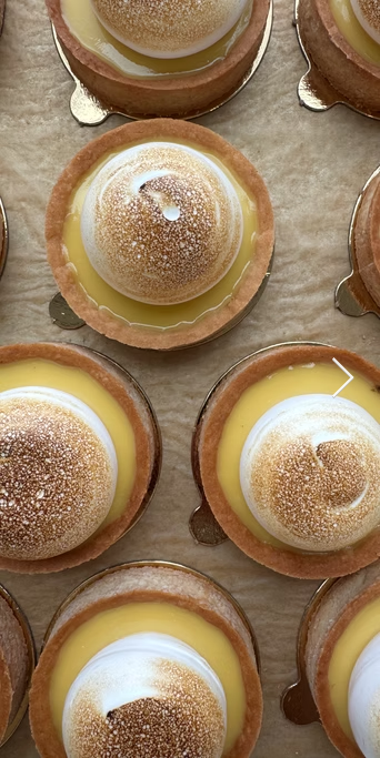 Small custard tarts on a ceramic surface
